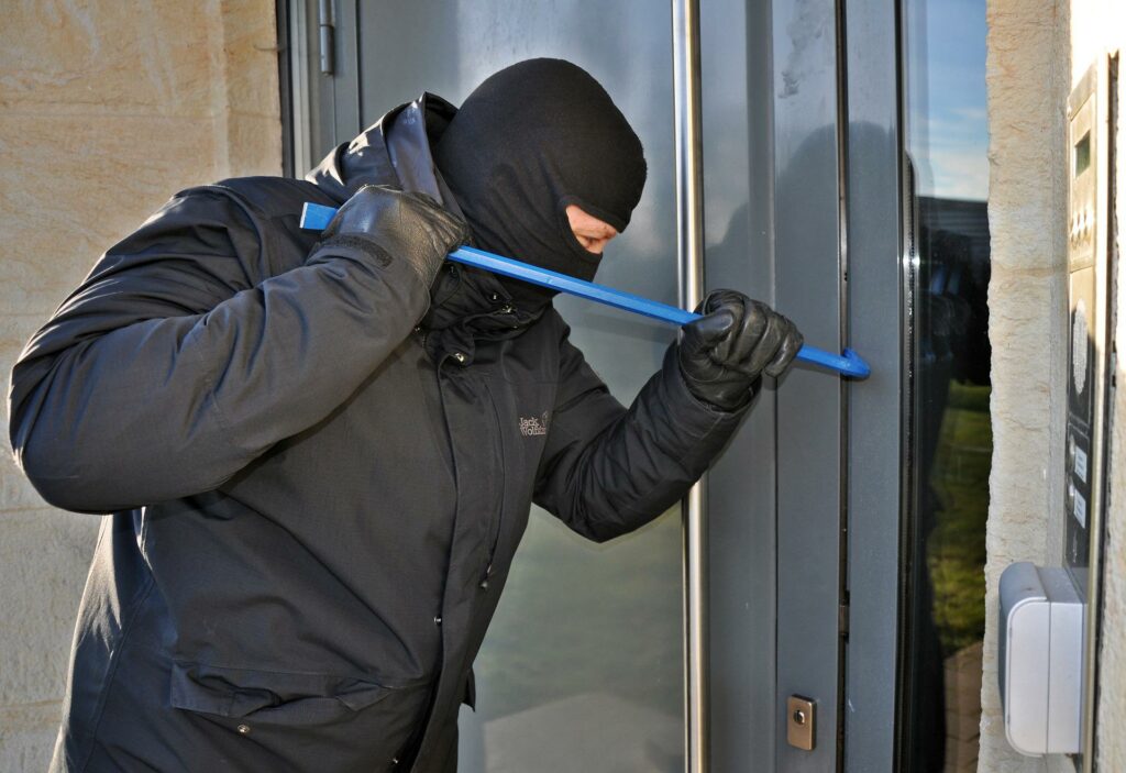 GFD Homes front door: Burglar attempting to break into a door.