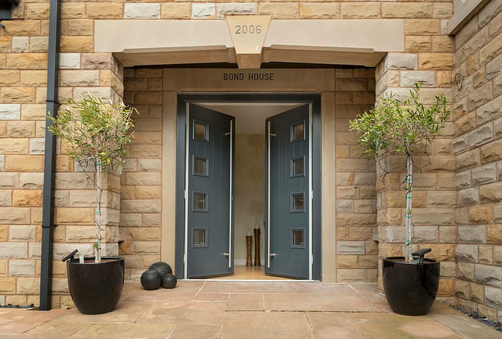 GFD Homes what is a composite front door: Solidor french door half opened, showing the entrance. 