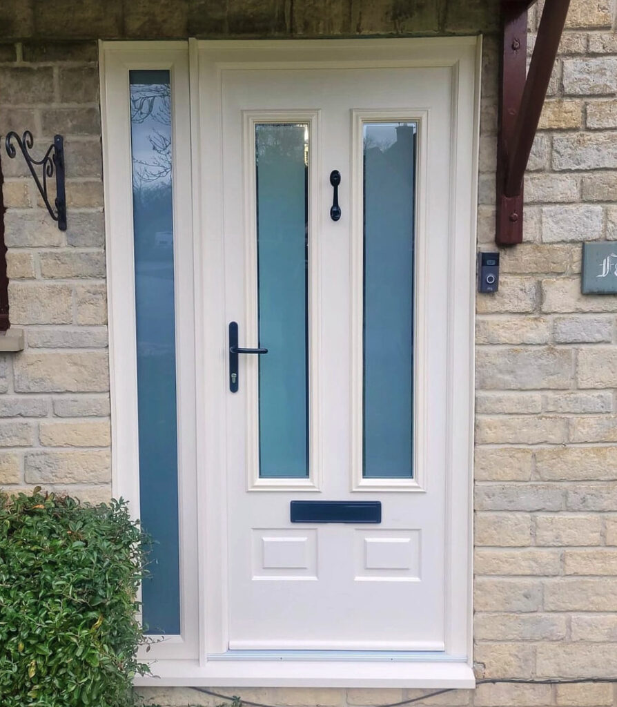 GFD Homes Comp Door Aston installed in a home with a side panel on the left side of the door.