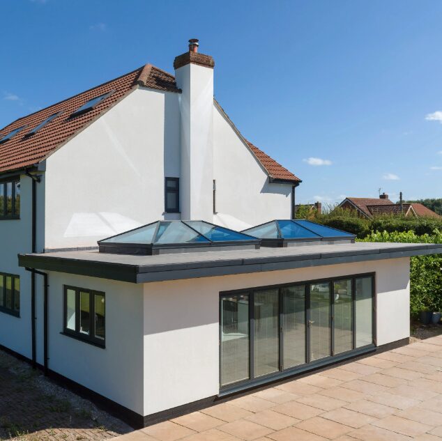 GFD Homes 2 Korniche roof lanterns installed on a flat roof with bifolds in sight. 