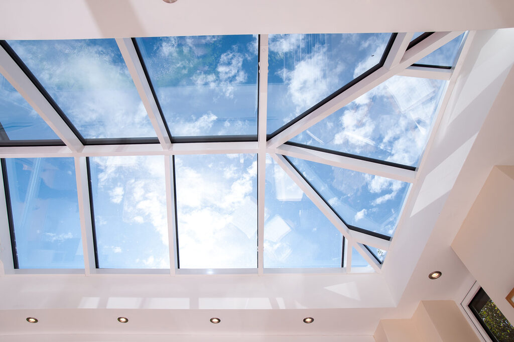 GFD Homes Roof lantern from below with blue skies and clouds in the background. 