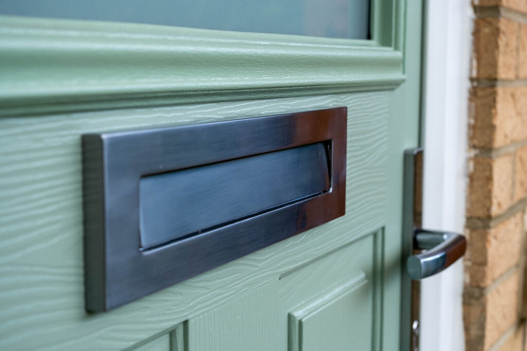 GFD Homes Door sill: Close up of a Comp Door composite door. 