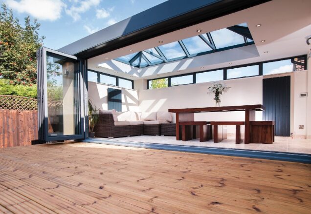 GFD Homes Large roof lantern installed on living room roof with bifold patio doors fully opened. 
