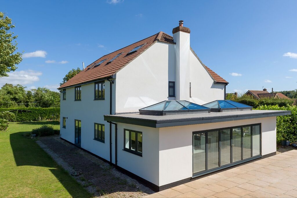 GFD Homes Home side view of 2 Roof lanterns installed on a flat roof with bifold patio doors. 