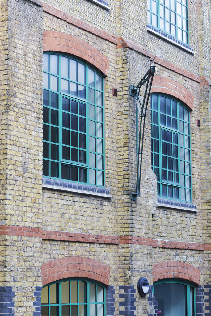 GFD Homes grey aluminium windows: Exterior shot of a green aluminium window 