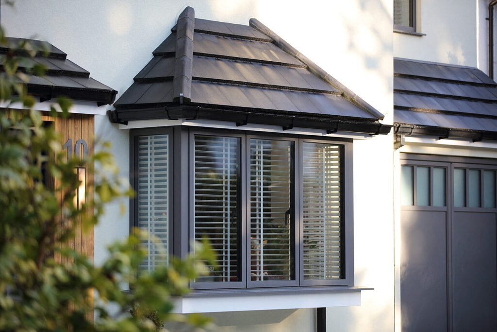 GFD Homes grey aluminium windows: Exterior shot of a grey aluminium window modern looking home