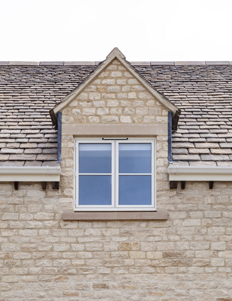 GFD Homes aluminium windows near me: outside shot an upstairs smart aluminium windows on a sandy brick house 