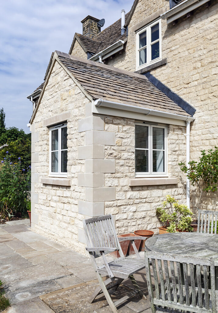 GFD Homes aluminium windows near me: outside shot of some smart aluminium windows on a sandy brick house 