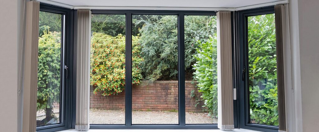 aluminium window frames: Interior shot a black aluminium window frames looking out onto a driveaway with crystal clear clarity
