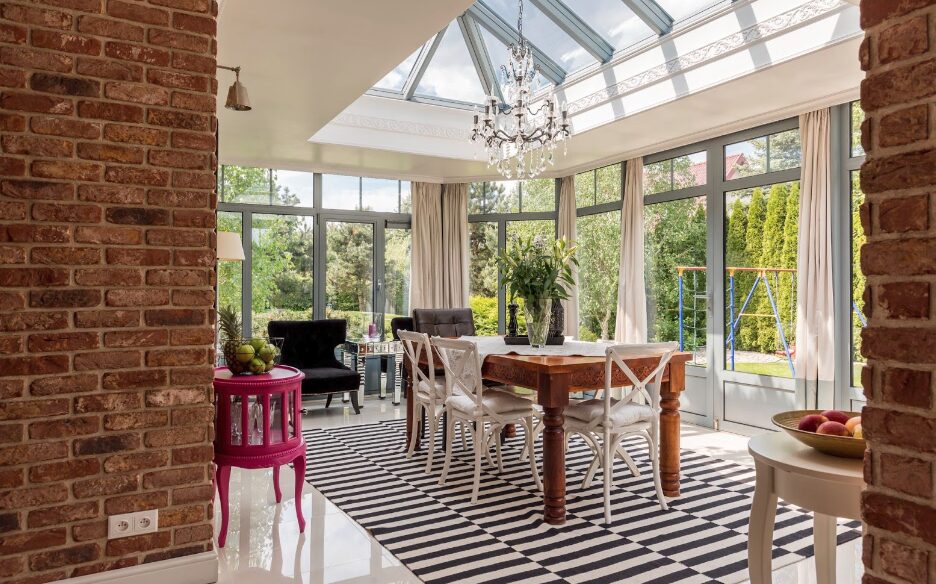 GFD Homes Large roof lantern installed above table with chandelier hanging above table. 