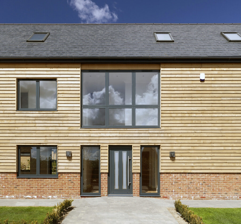 GFD Homes upvc vs aluminium windows: Building with large glass aluminium windows installed. 