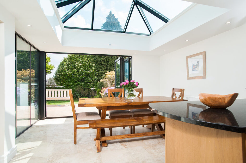 GFD Homes A small lantern roof extension with bifolding doors opening out into a patio area 