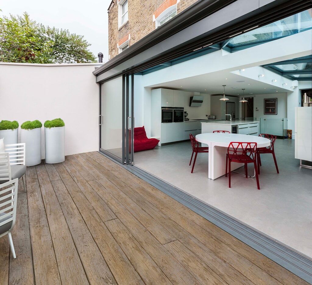 GFD Homes Bifold doors fully opened to allow access from the kitchen to the patio. 