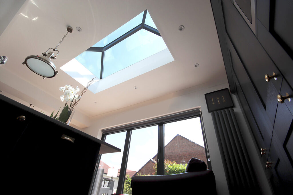 GFD Homes how to add value to your home : interior shot of a roof lantern beaming in light onto a home bar 