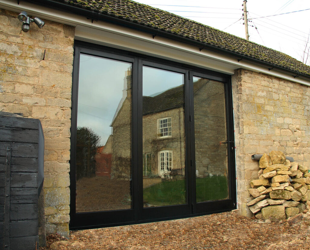 GFD Homes do you need planning permission for bifold doors: Smart 3 pane bifold door in black with the doors closed.