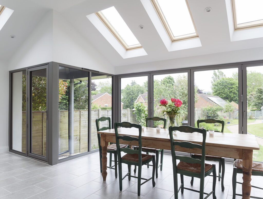 GFD Homes how to adjust bifold doors: Large 4 pane bifold closed, with dining table in view. 