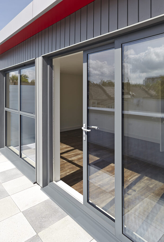 GFD Homes aluminium patio door work : sliding door half open with sun falling into the room. 