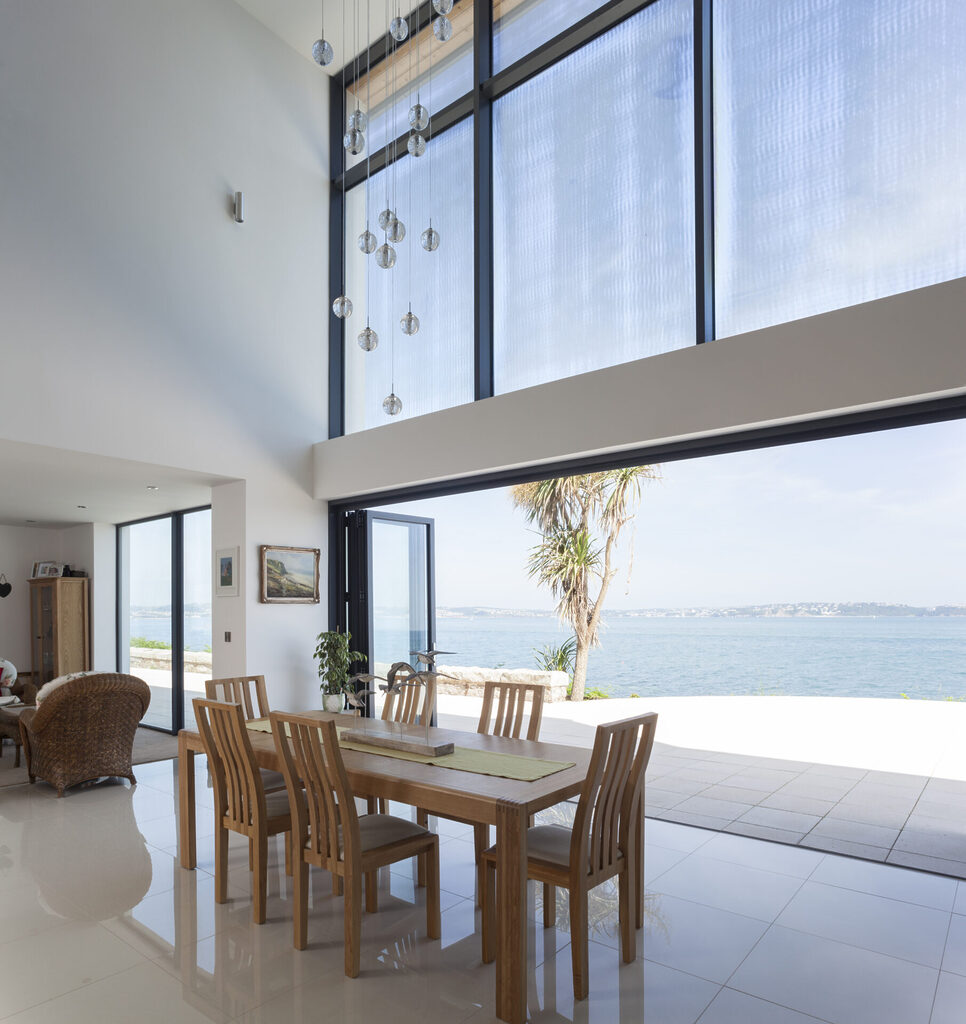 do bifold doors add value : Large bifold door fully opened to show sea view. 
