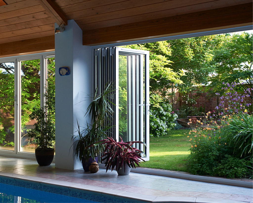 GFD Homes can you replace patio doors with bifold doors : looking outside from a pulled across bifold door into a garden 