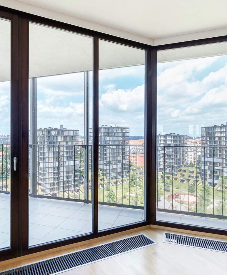 GFD Homes aluminium bifold doors: aluspace internal screening solution in an office setting with background views 