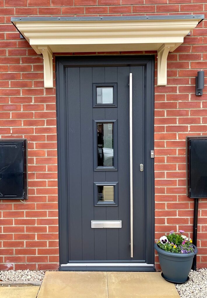 door measurements uk: Comp Door composite door installed on a home with brick walls on the side. 