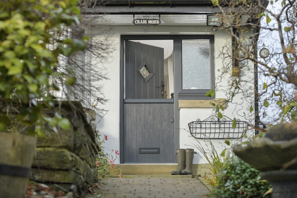 GFD Homes Stable Doors : black stable door in a cottage setting