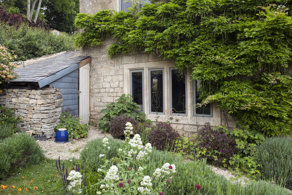 GFD Homes Smart Industrial Style Windows : grey smart industrial style windows in a cottage surrounded by foliage 