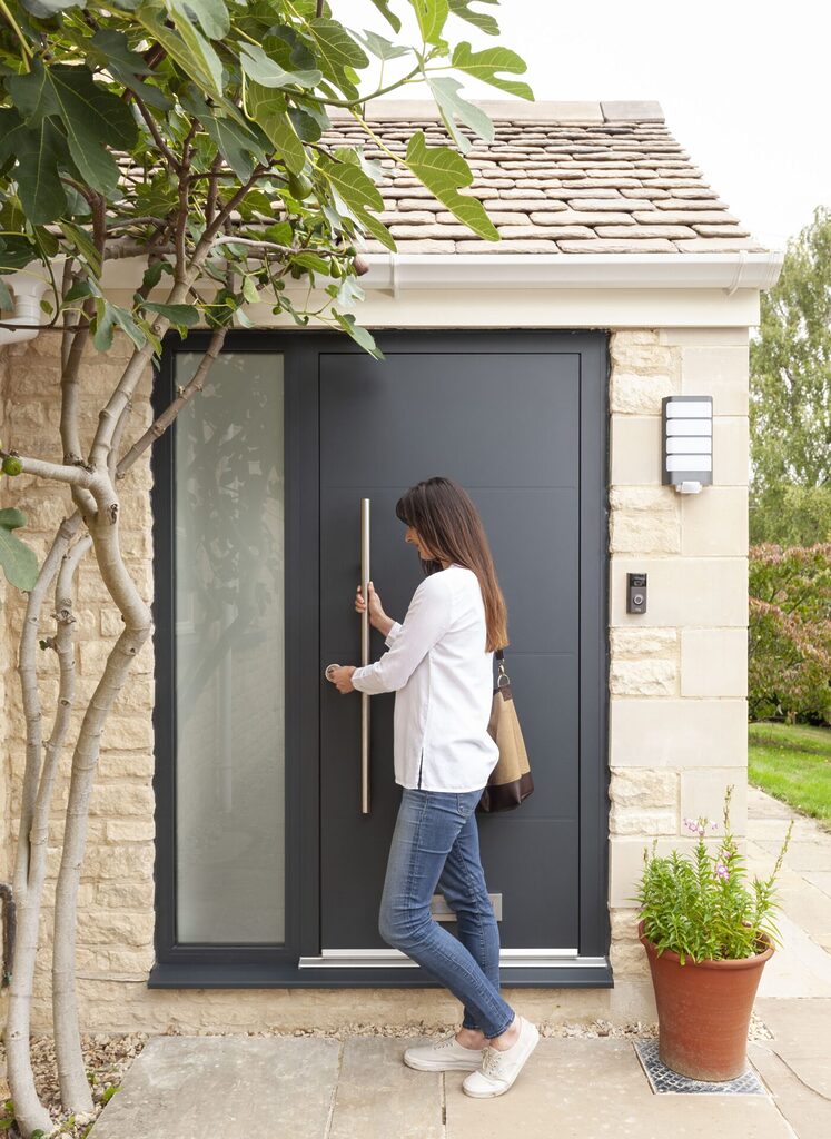 GFD Homes Chinese New Year 2025: Lady turning key to open large black door. 