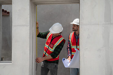 door measurements uk: builders measuring for a door