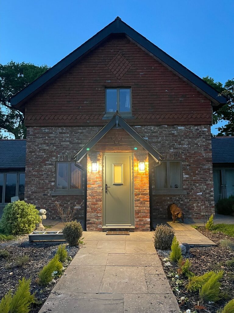 GFD Homes Aluminium front doors : smart designer door in a rustic setting looking up from the pathway 