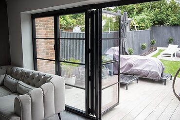 Bifold Doors: bifold door open with patio area in view.