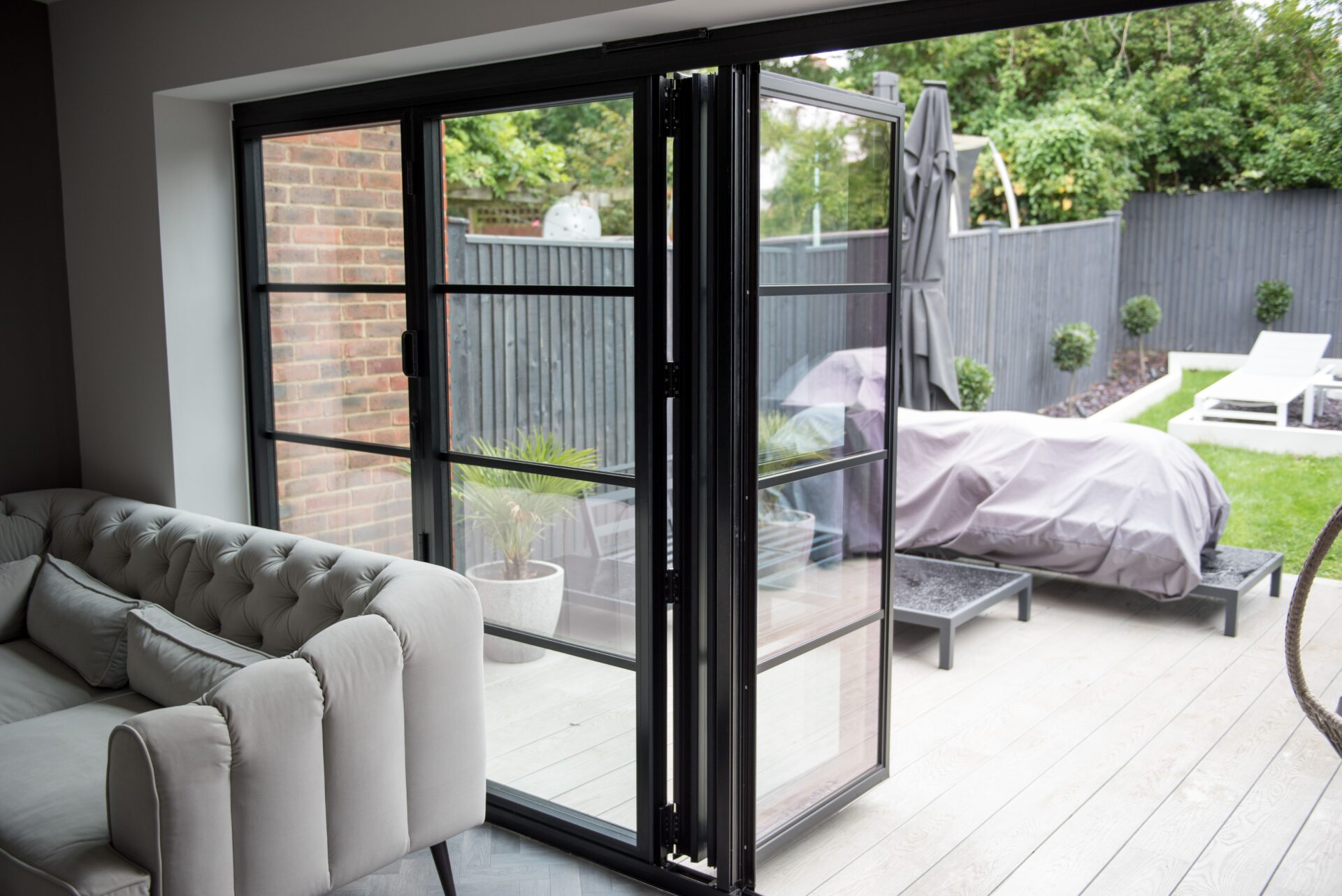 GFD Homes Bifold Doors: bifold door open with patio area in view.