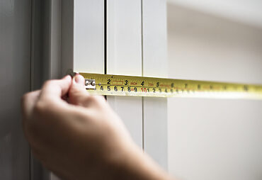 standard doorway measurements: hand measuring with tape