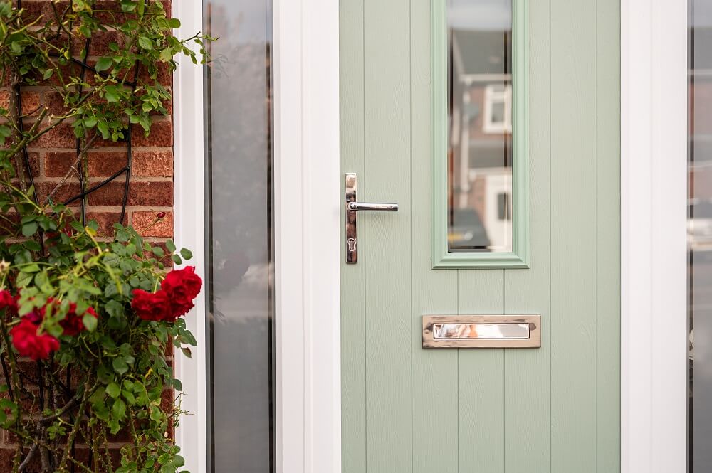 Comp Door : mint comp door with sidelights behind a rose bush 