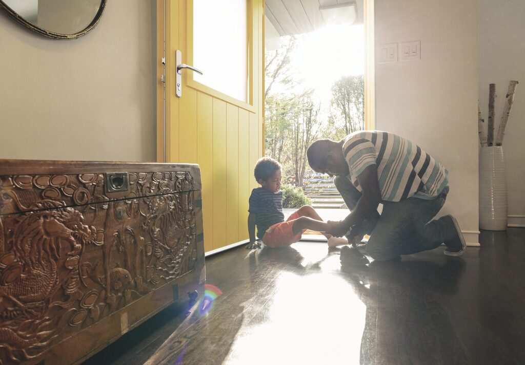 Signature Aluminium Doors : family infront of a yellow smart signature door