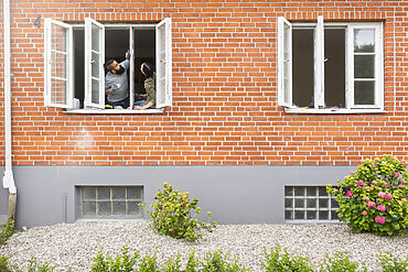 windows: home with windows open and couple staring at windows from inside