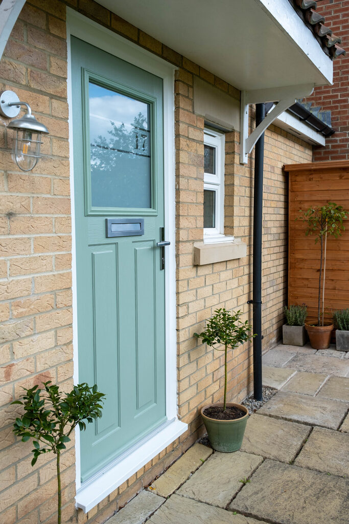 cottage doors: chartwell green comp door installed on home. 