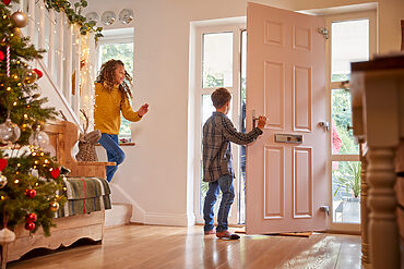 composite front doors: kid opening door halfway