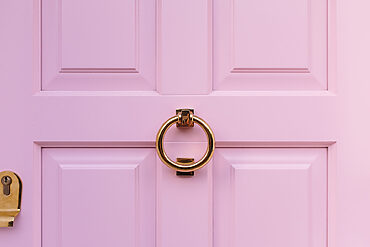 door colours: pink door with gold knocker zoomed in