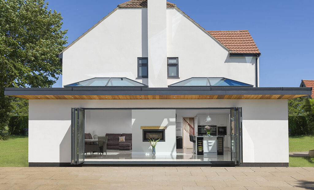 korniche roof lantern installation: home with 2 roof lanterns and large bifold door open wide. 