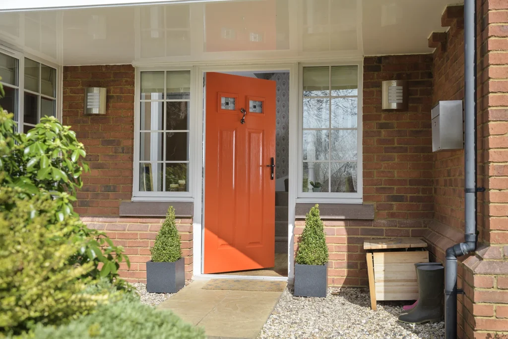 door and frame : orange solidor door with a white frame 