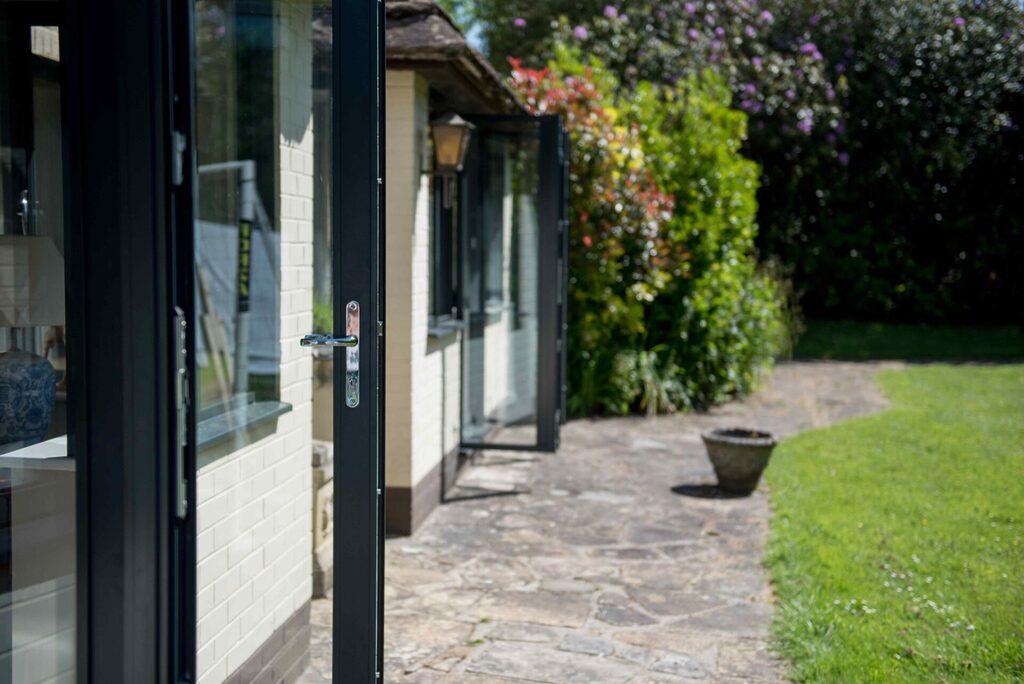 aluminium french doors: Aluminium doors open out onto patio - side view