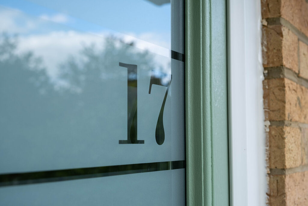 composite front doors: door glazing zoomed in to show door number and frame.  