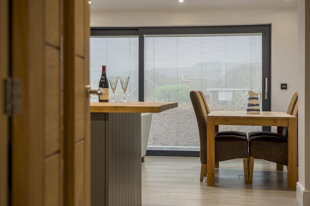 aluminium sliding doors: sliding doors fitted in living room with garden in view 